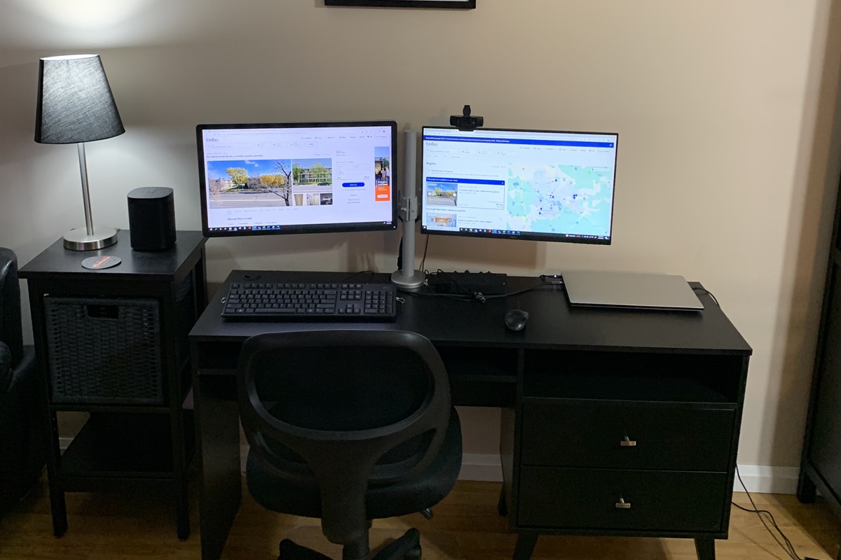 Computer desk with two monitors, smart hub and office chair. Perfect spot to log in and catch up.