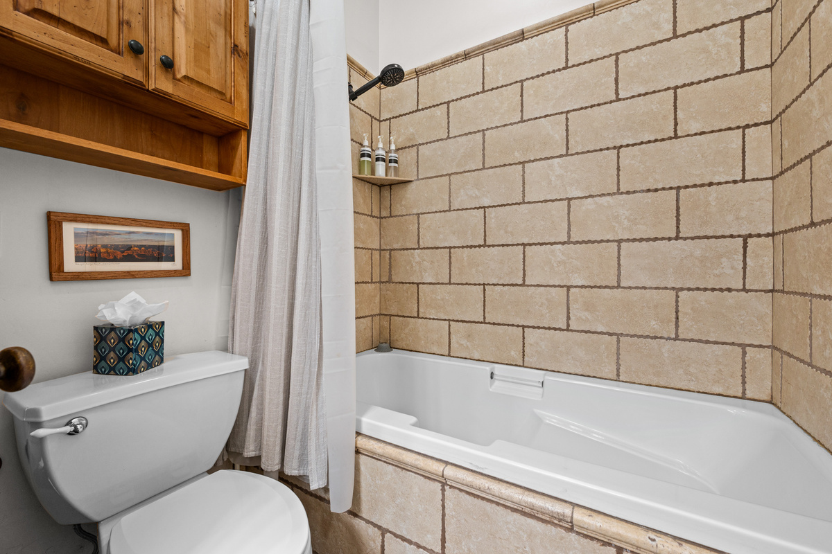 The full bathroom features a tub/shower combo, spacious vanity, and all the essentials for a comfortable stay.