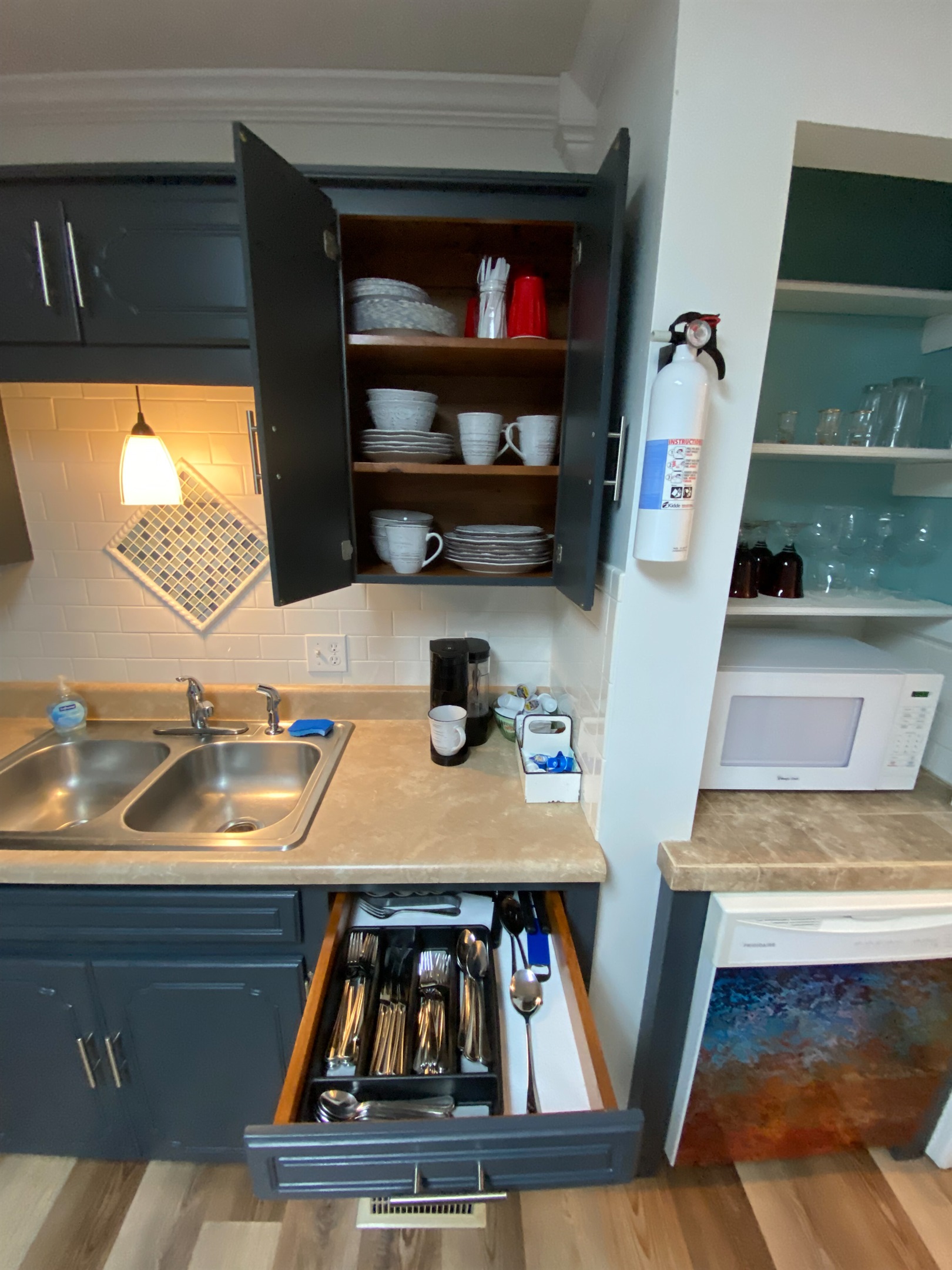 Plates, coffee station, silverware, and pots and pans