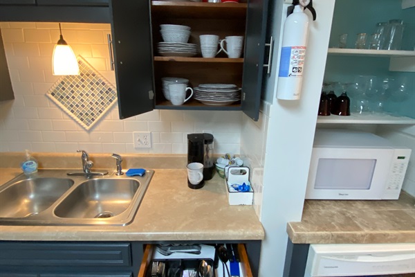 Plates, coffee station, silverware, and pots and pans