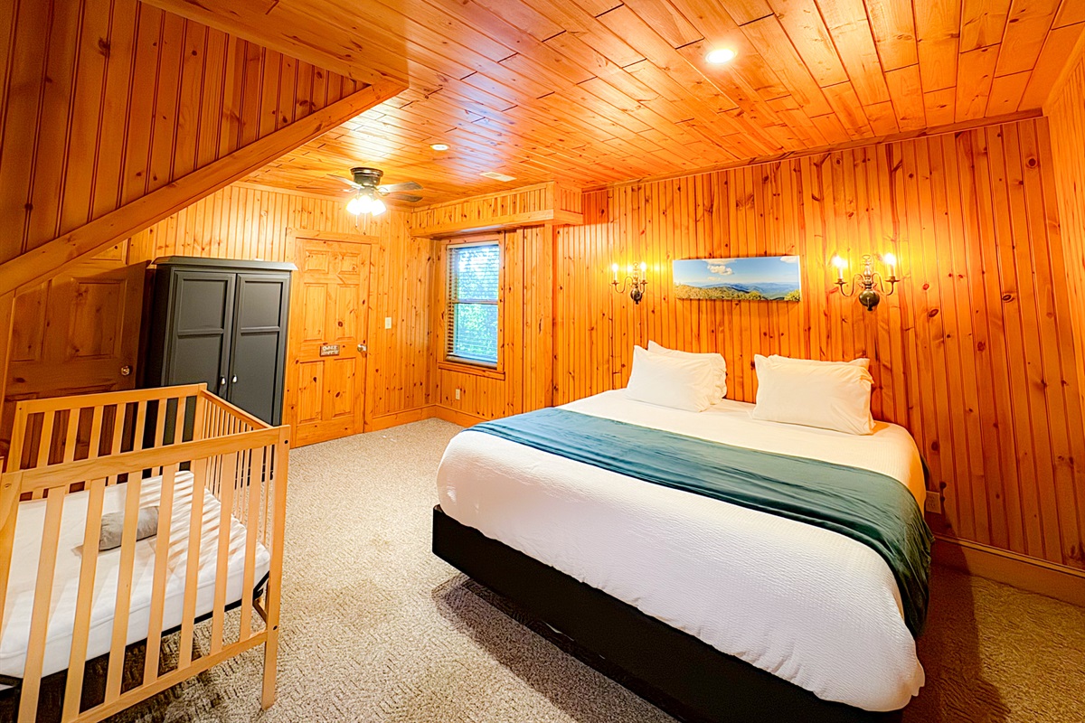large bedroom one the lower level with a king bed, crib/pack-n-play, twin bed