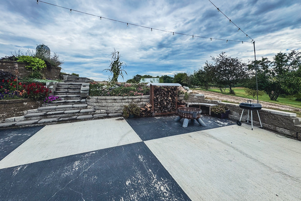 Patio fire pit and grill beside the landscaped steps.