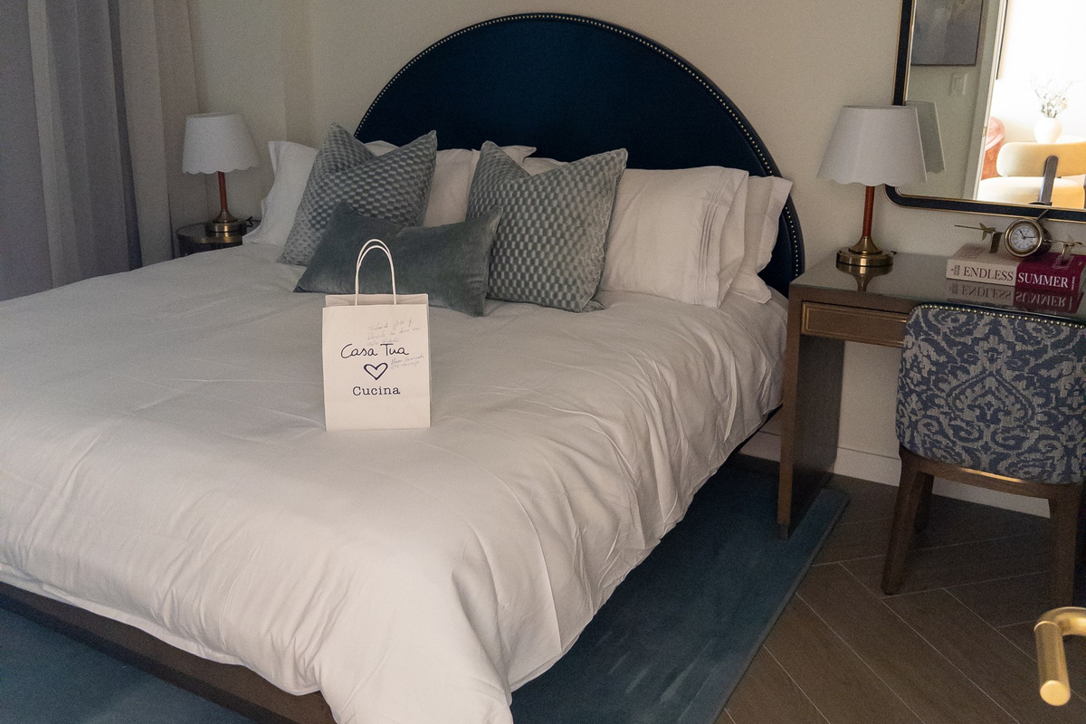 Drift off in the king suite - designer navy headboard, crisp linens and a welcome gift on arrival.