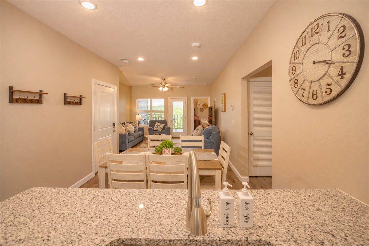 Bright open layout connecting kitchen, dining, and living spaces