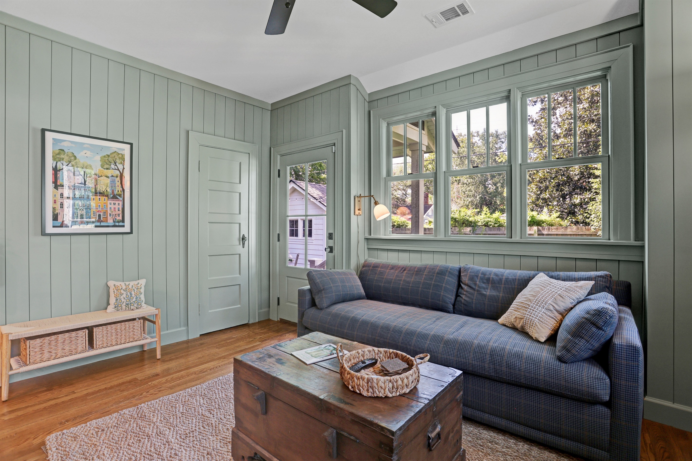 Surrounded by windows and lush greenery, the sunroom invites you to slow down and unwind.