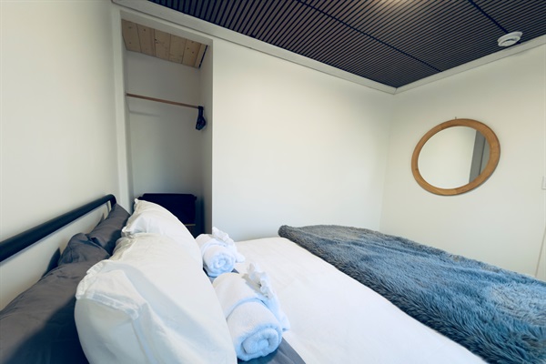 Another view of the queen bedroom showing full layout and large mirror