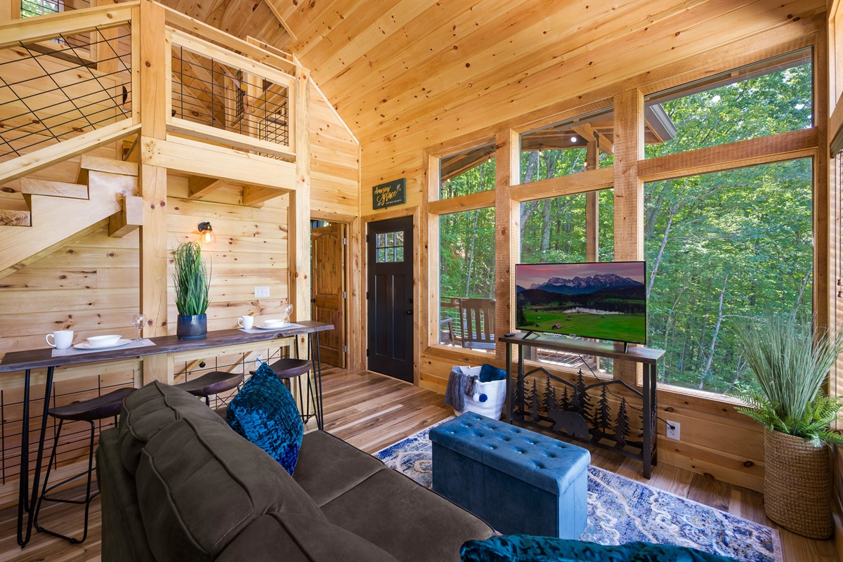 Juniper Cottage Living room view with door to back deck