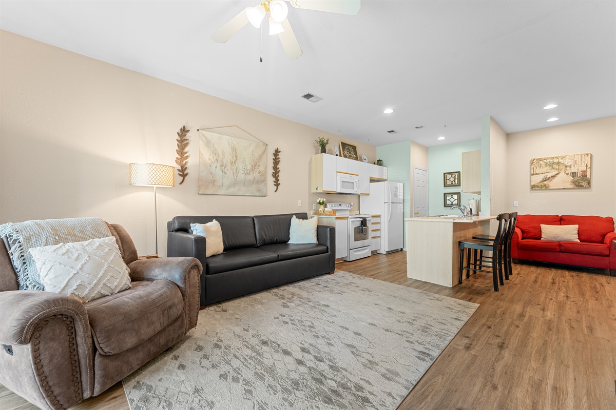 Another wide look at the living room and kitchen, with flexible seating and room to spread out.