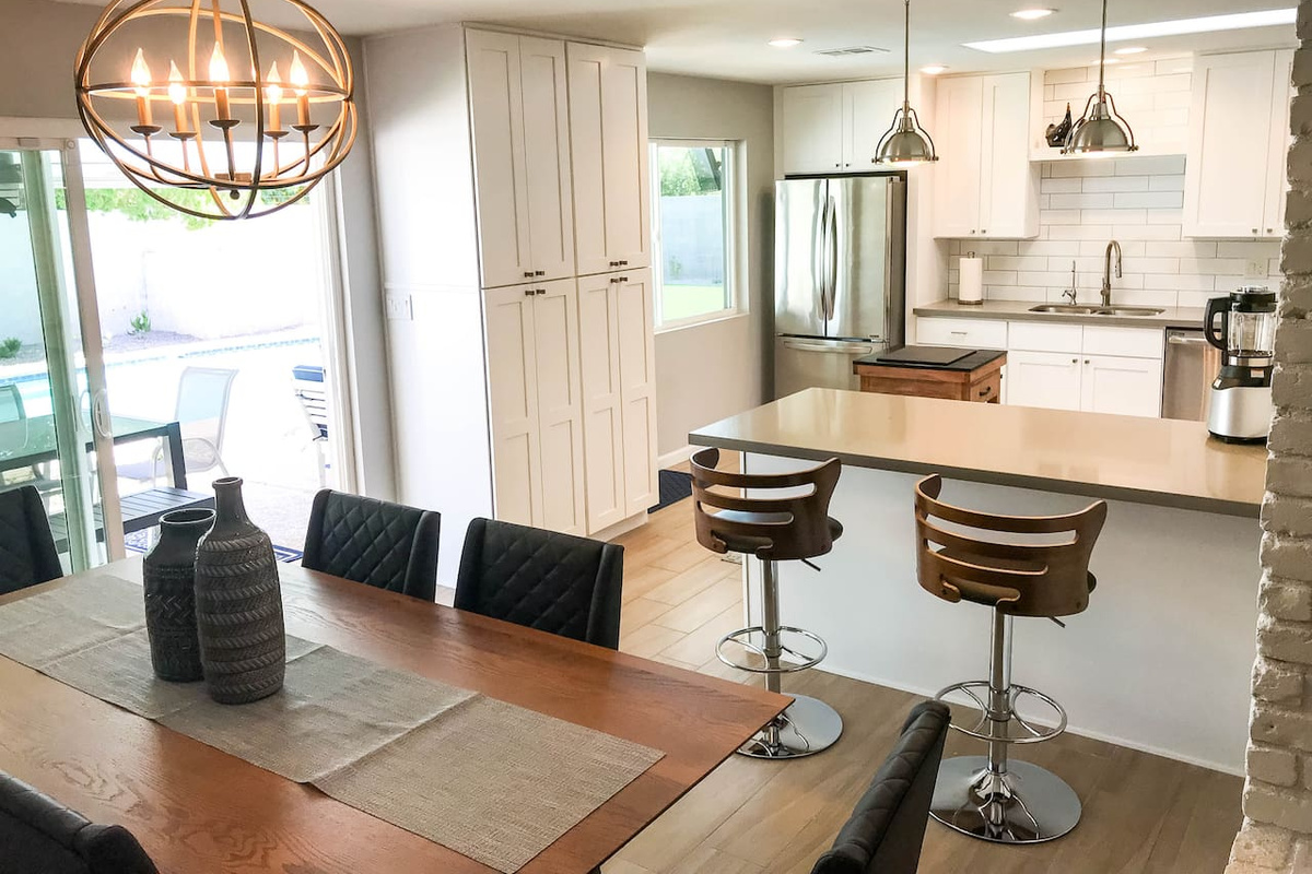 Bright airy kitchen with windows, sliders, and sky light.