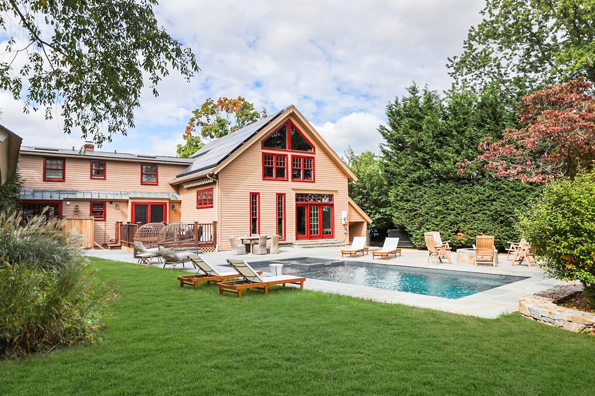 Outdoor area adjoining two homes with room to run around on the grass.