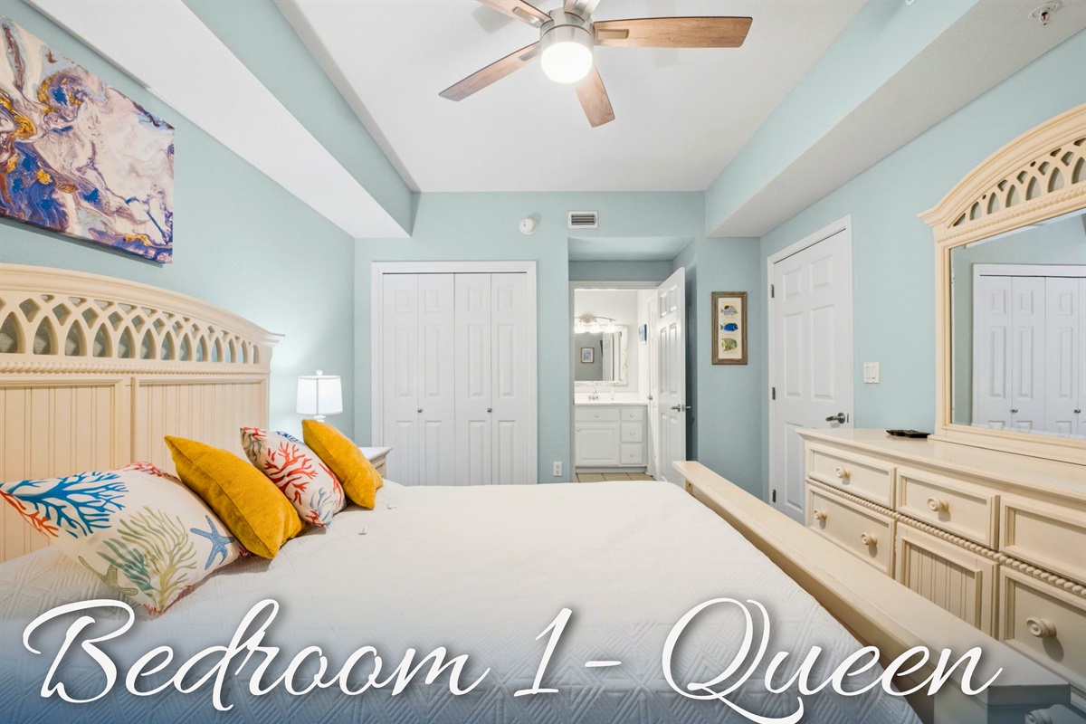 Bedroom 1 features a comfortable bed and a calm coastal design for restful nights after sunny beach days.
