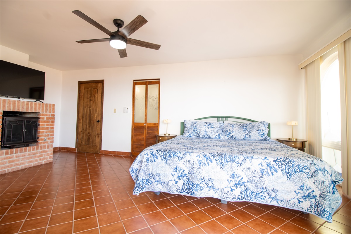 Principal Bedroom with King Bed, Fireplace, suite bathroom, and balcony.