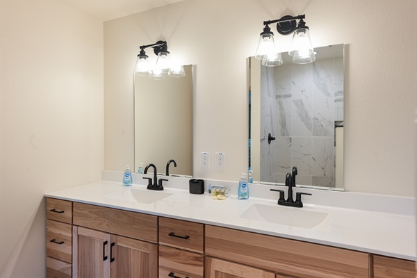 Master ensuite with double sinks, toiletries, and towels provided.