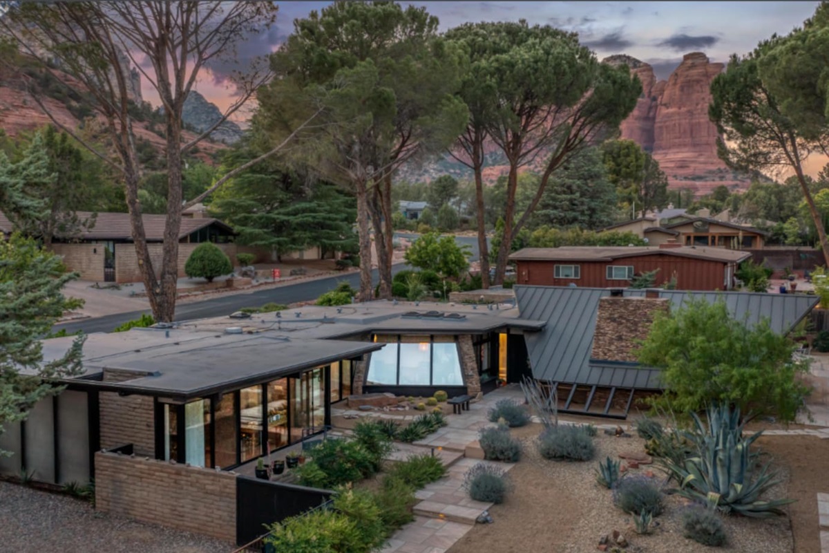 Stunning aerial view of this iconic mid-century retreat, surrounded by mature trees and dramatic red rock formations — a truly unforgettable setting where modern design meets Sedona’s natural beauty.