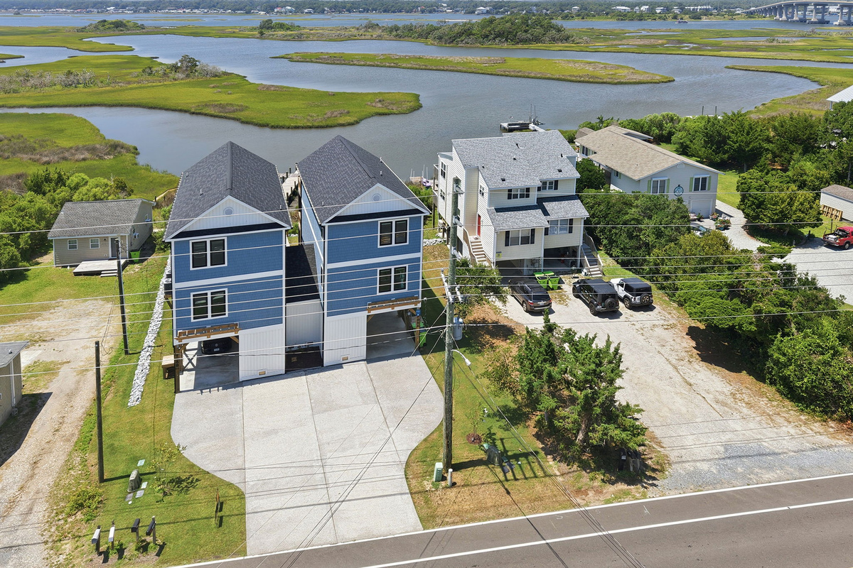 Enjoy panoramic views of the surrounding marshlands, waterways, and nearby bridge from this beautiful waterfront setting