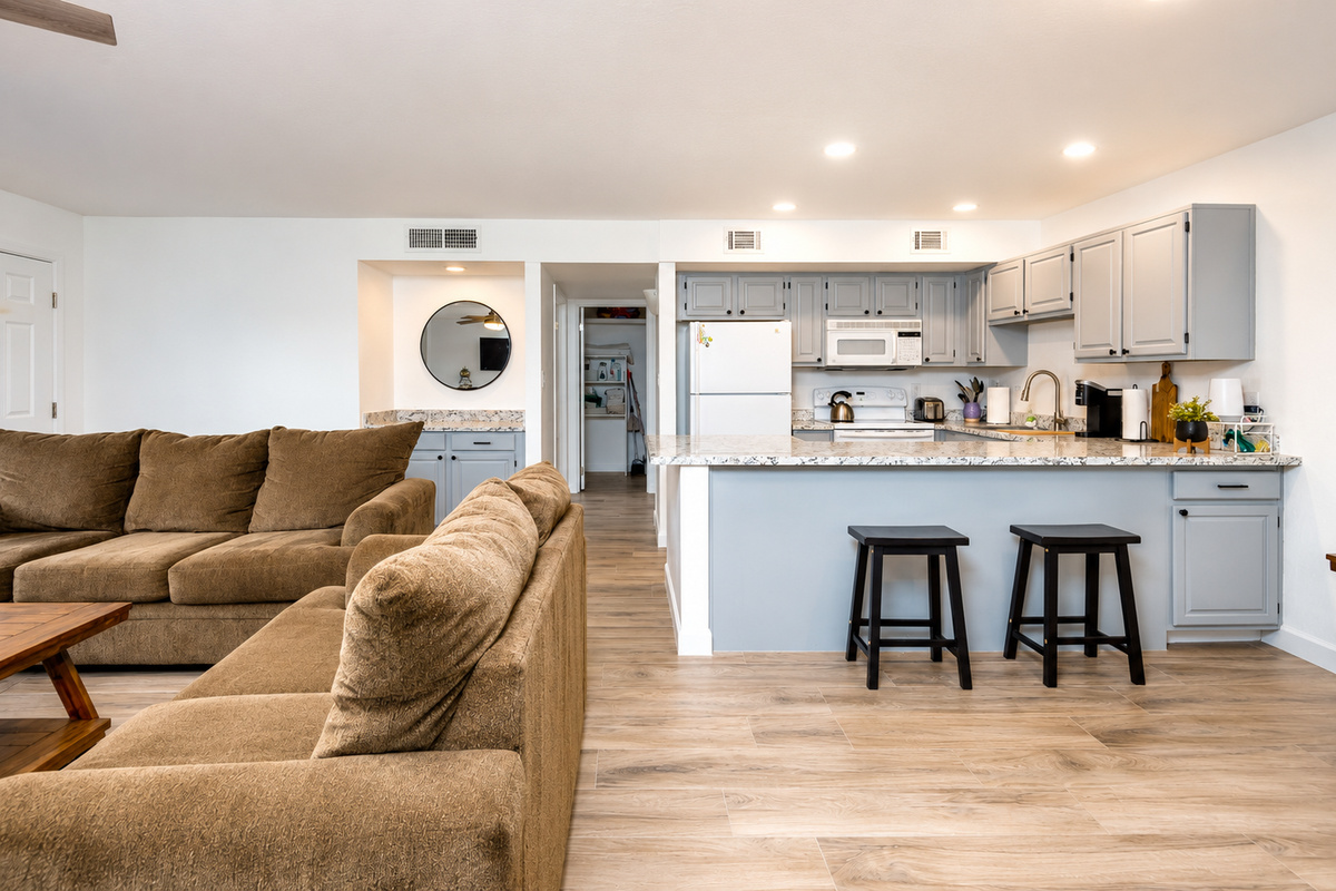 Living room with comfy seating, kitchen bar seating, and an open layout for easy meals and downtime.
