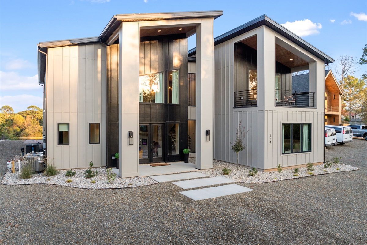 Another view of this contemporary exterior, inviting you to relax and unwind in comfort and style by the lake.