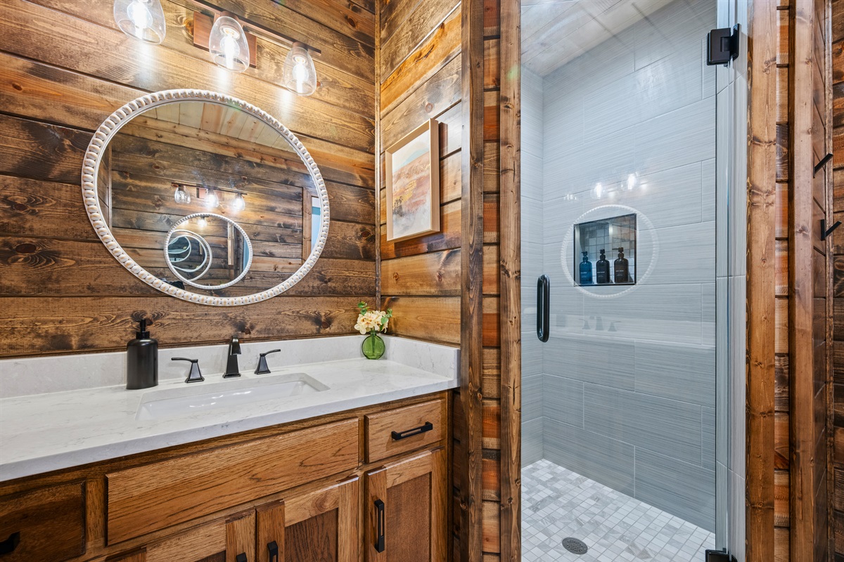 With a spacious shower and a beautiful vanity area, this bathroom feels like a simple little retreat that still has plenty of function.