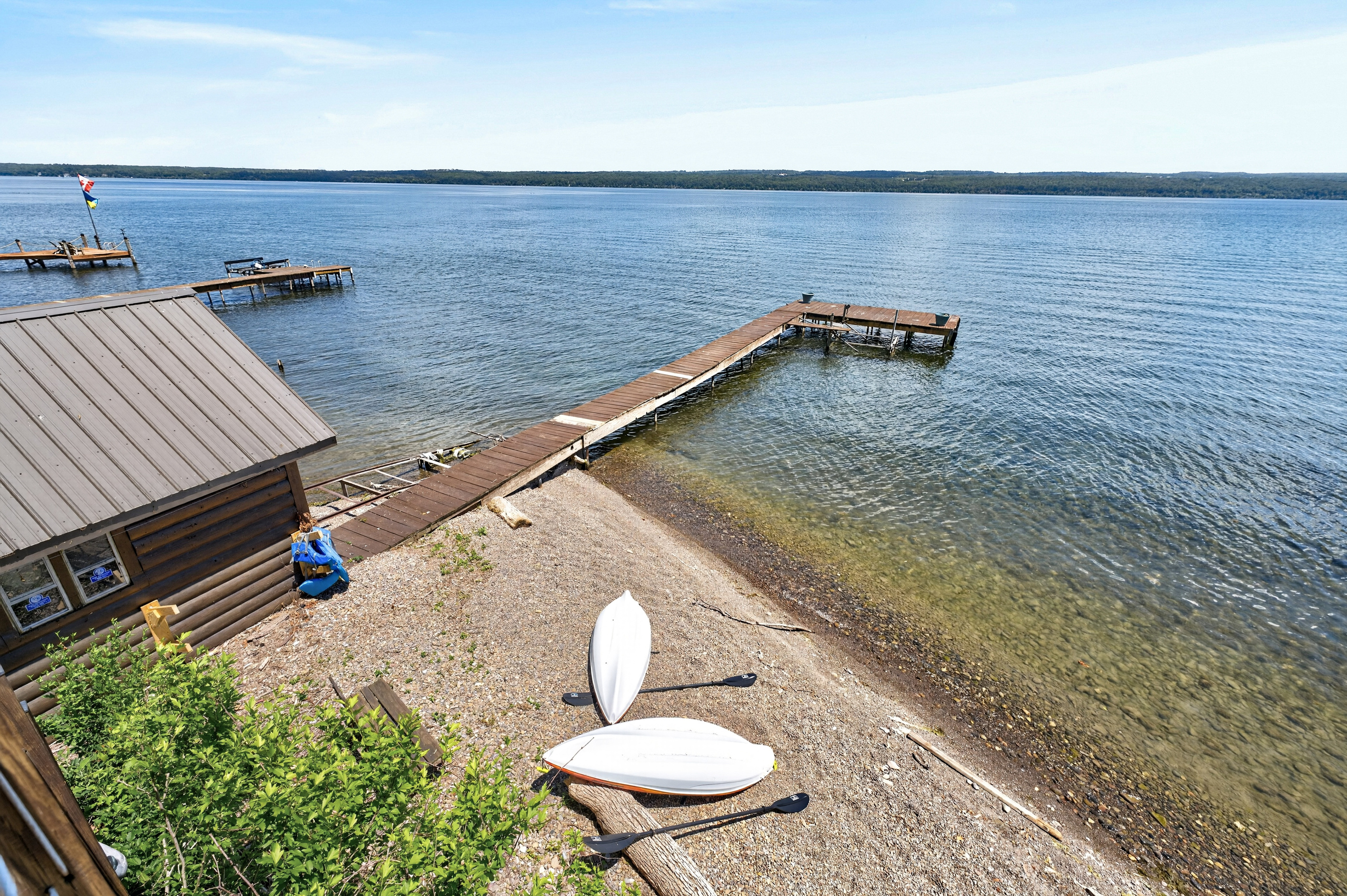 Kayaks resting on the pebbled shoreline
