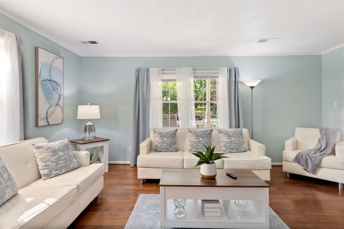 Spacious and sunlit, this cozy living room offers the perfect spot to read, reconnect, or relax in peace.