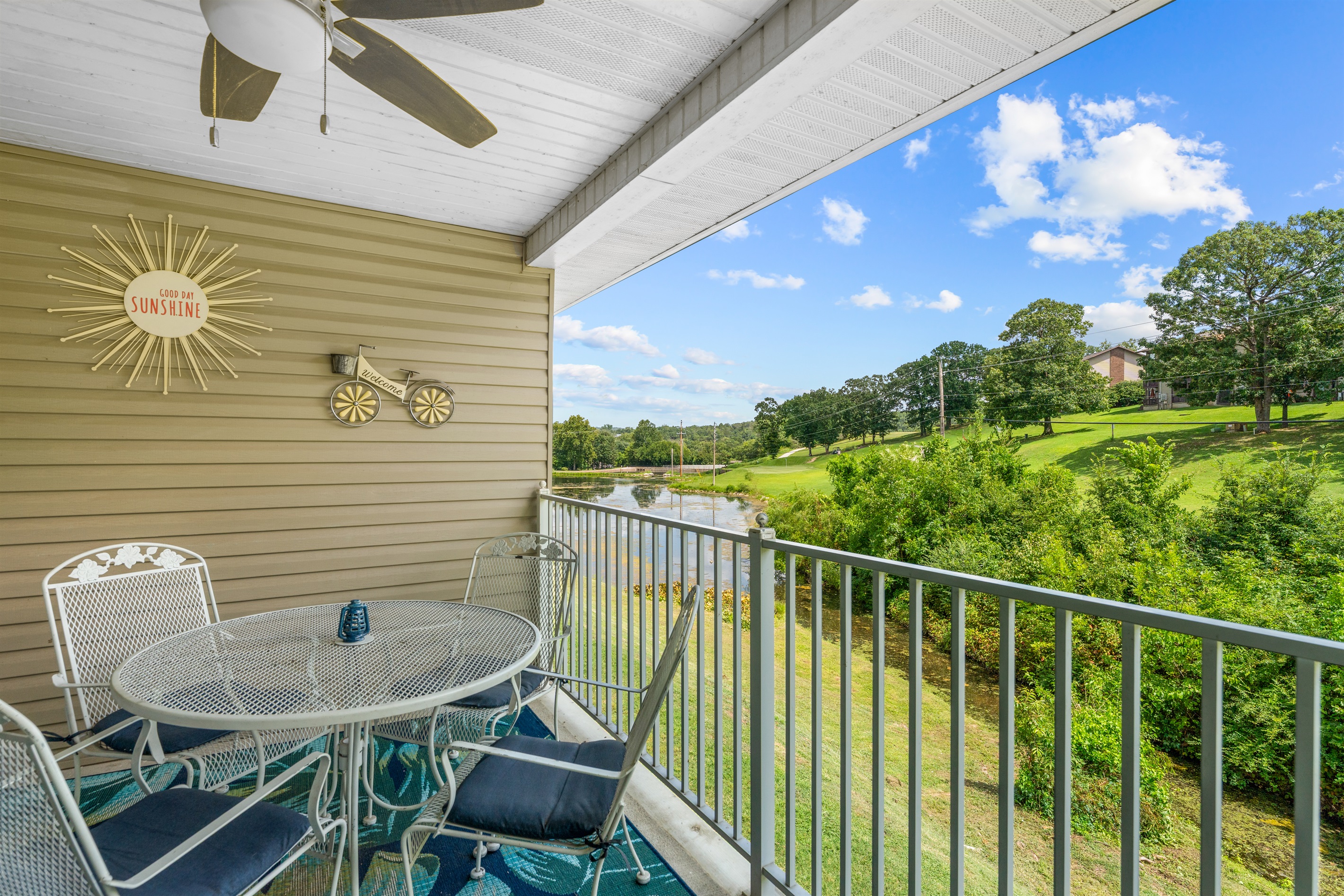 The private deck is made for slow mornings, card games, and peaceful views over the brook and neighboring greens.