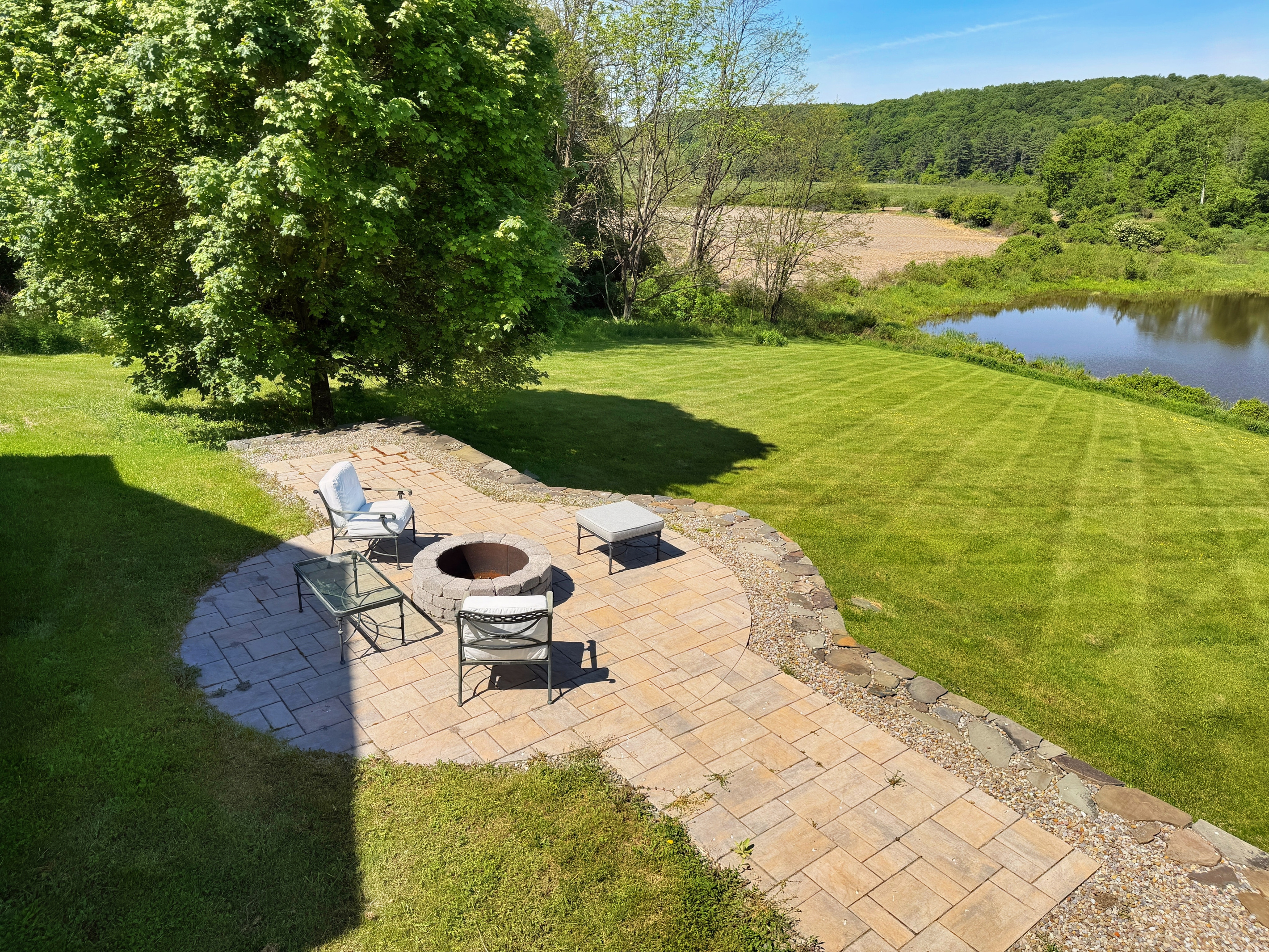 The fire pit in backyard overlooking the scenic pond.