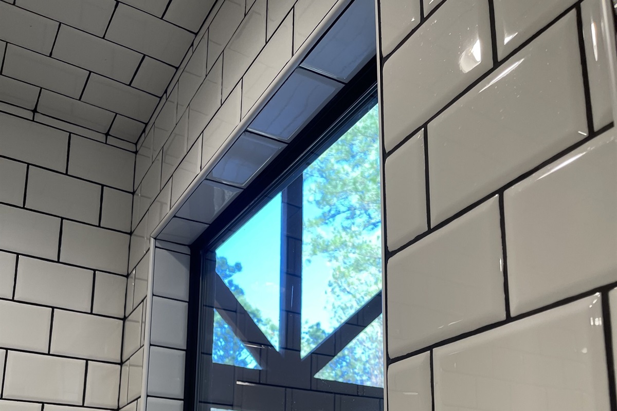 The entry of the large subway tiled shower.