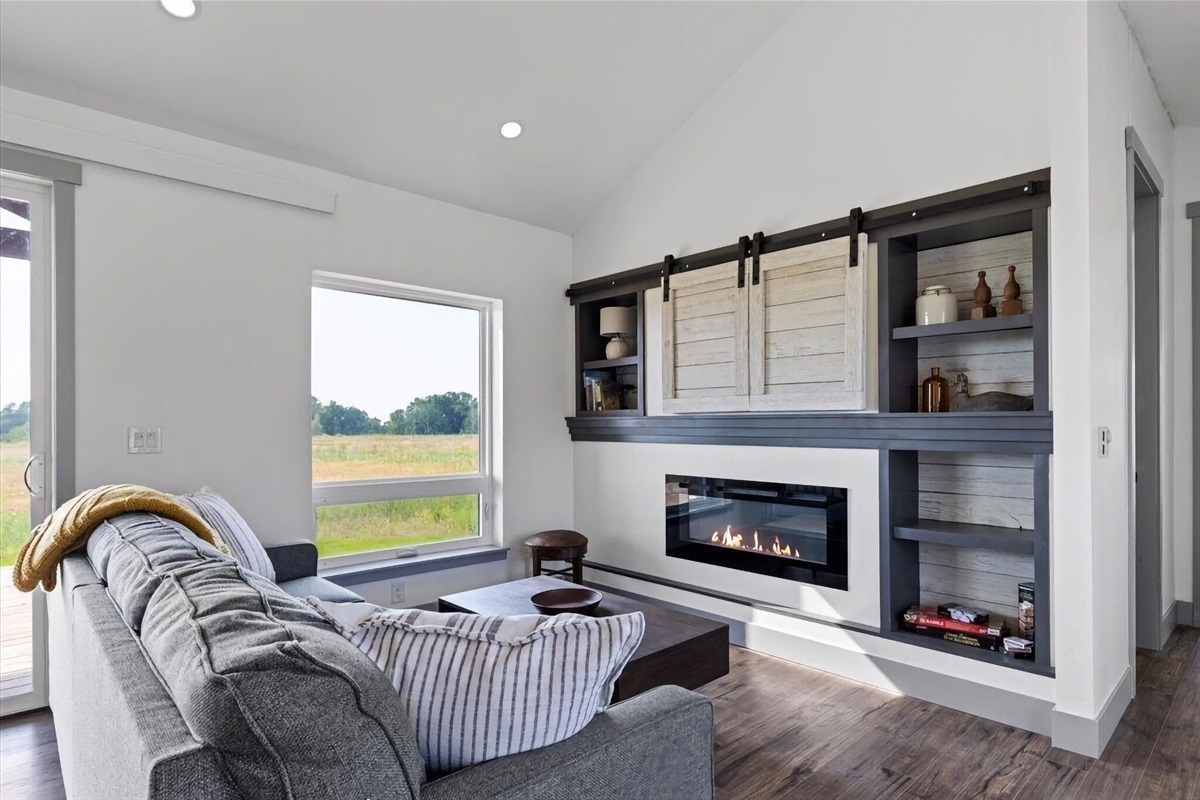 Kick back and relax in the living room, taking advantage of the inviting seating, a smart TV, and a cozy electric fireplace.