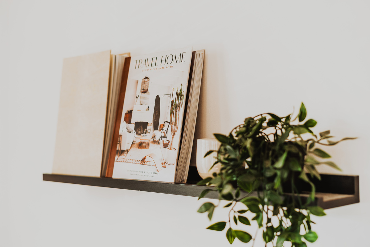 Wall Shelf Accent Detail with Books and Trailing Houseplant