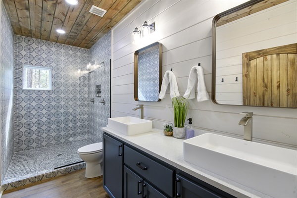 Hall bath features dual sinks and dual shower heads.