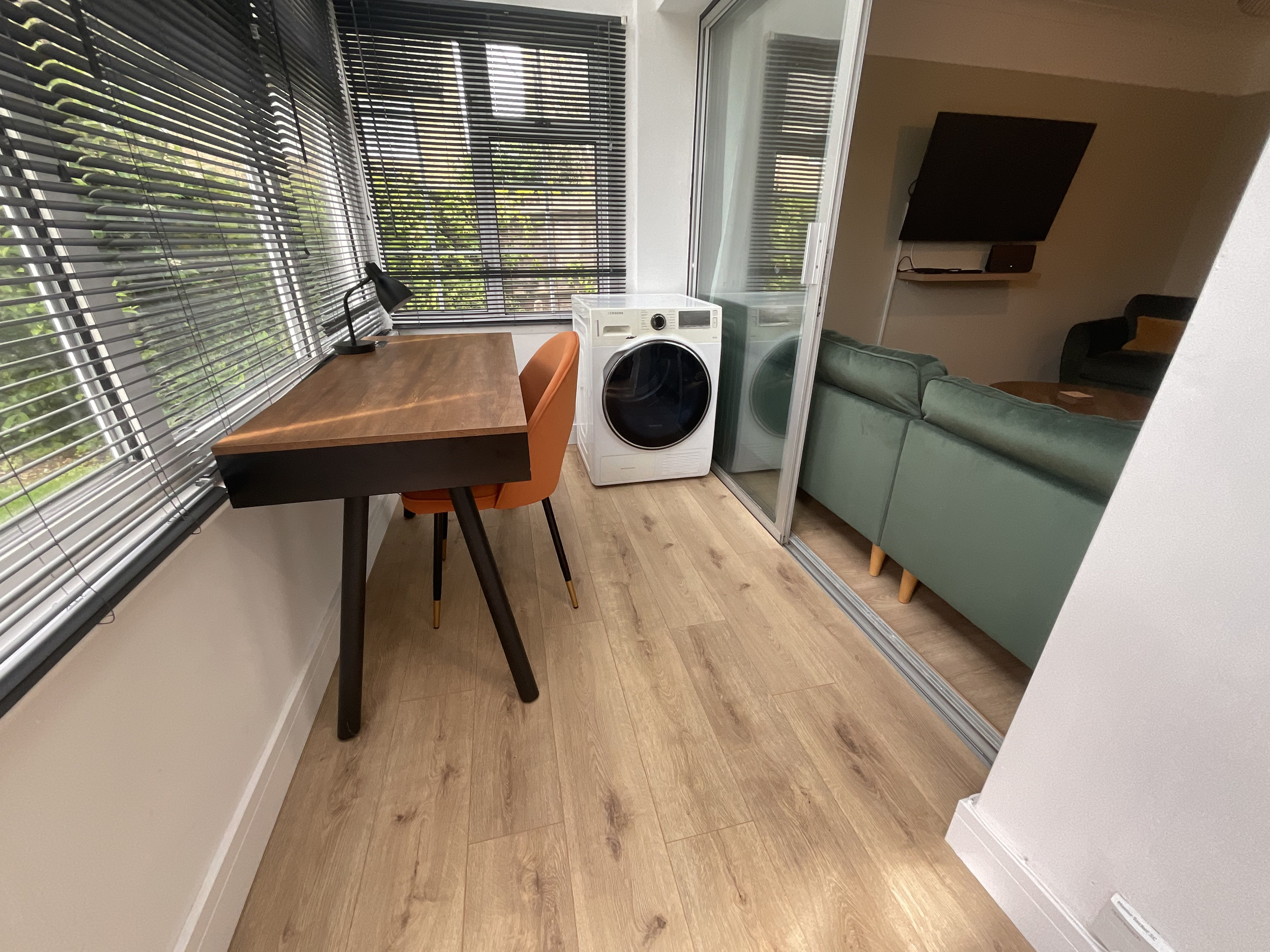 The porch area has a smart desk with WIFI speakers as well as the tumble dryer.