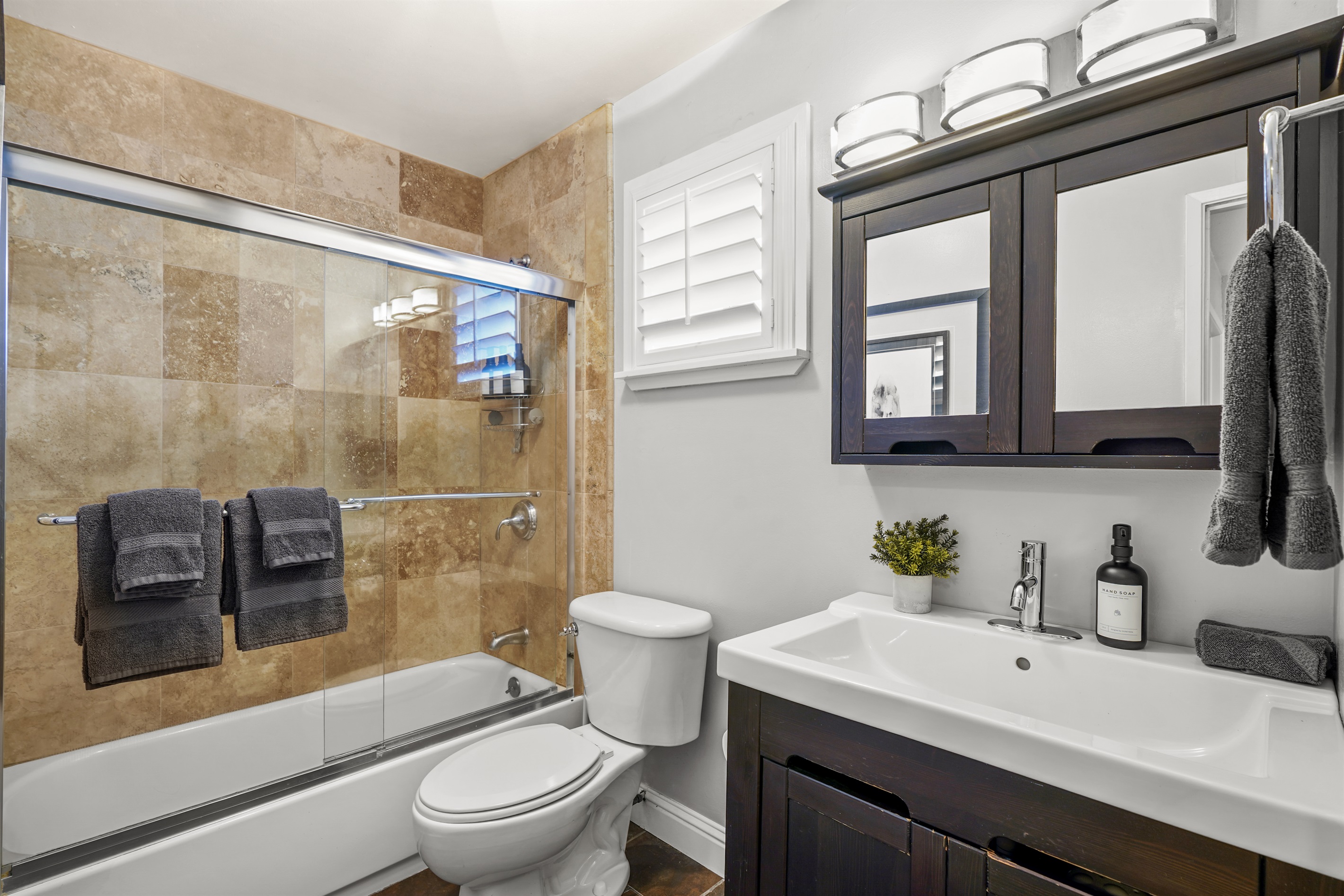 Full upstairs bathroom conveniently located near the additional guest bedrooms.