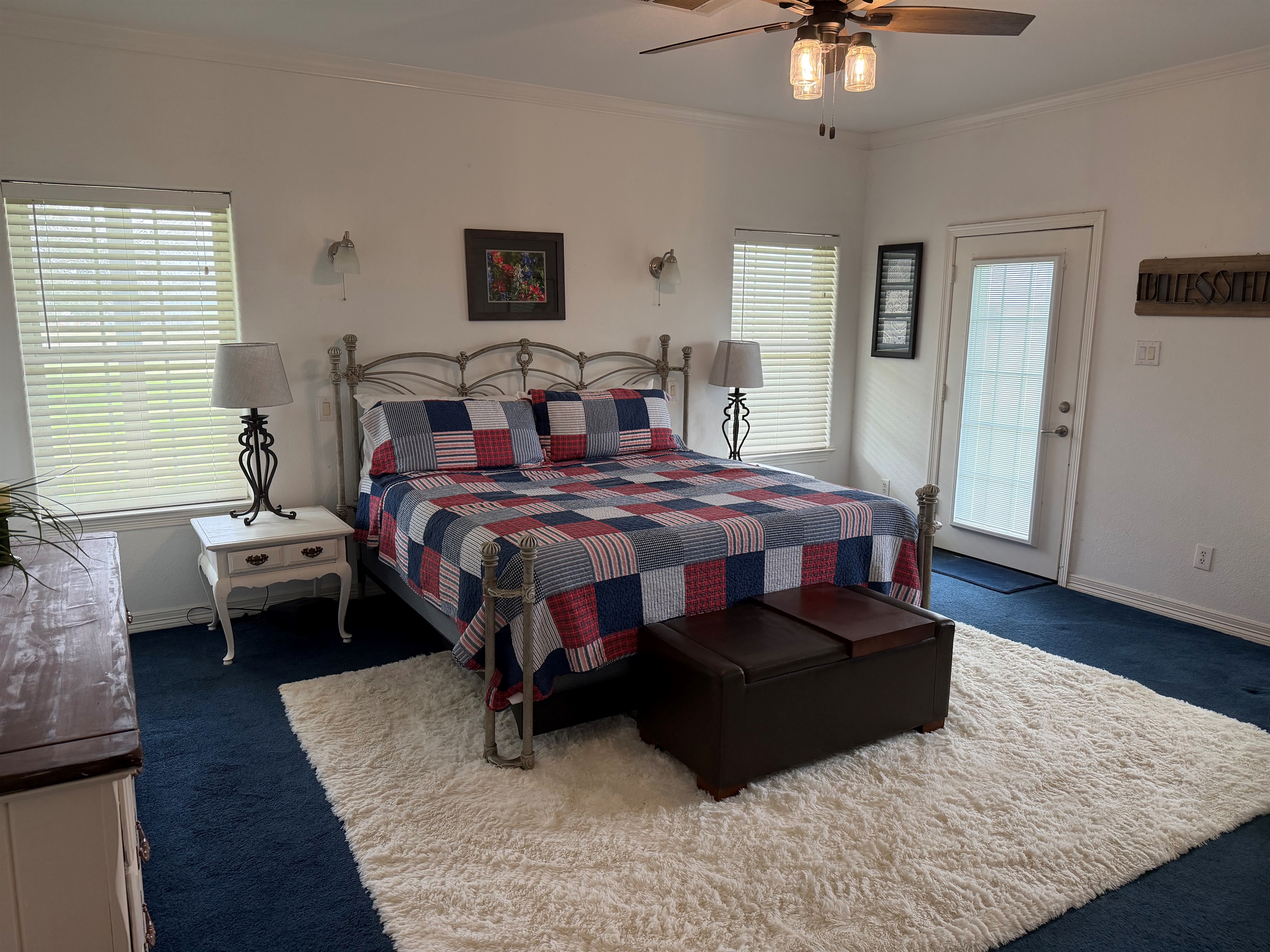 Red, white and blue theme master bedroom with separate private exit onto wraparound porch.