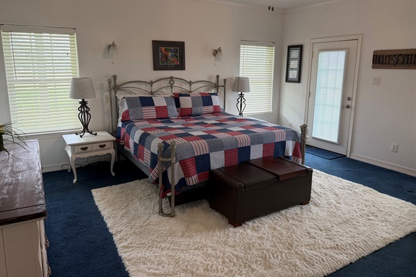 Red, white and blue theme master bedroom with separate private exit onto wraparound porch.
