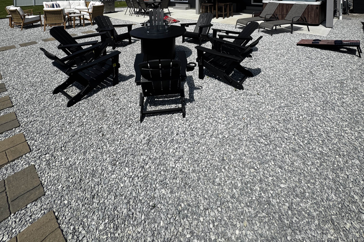 Outdoor fire pit seating area with surrounding lounge chairs—perfect for relaxing and gathering by the waterfront.