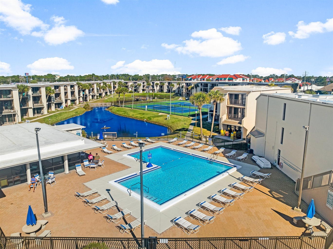 private pool and pickleball courts surrounded by relaxing pond