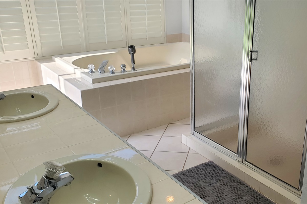King private bathroom with jet tub and walk in shower, double sinks