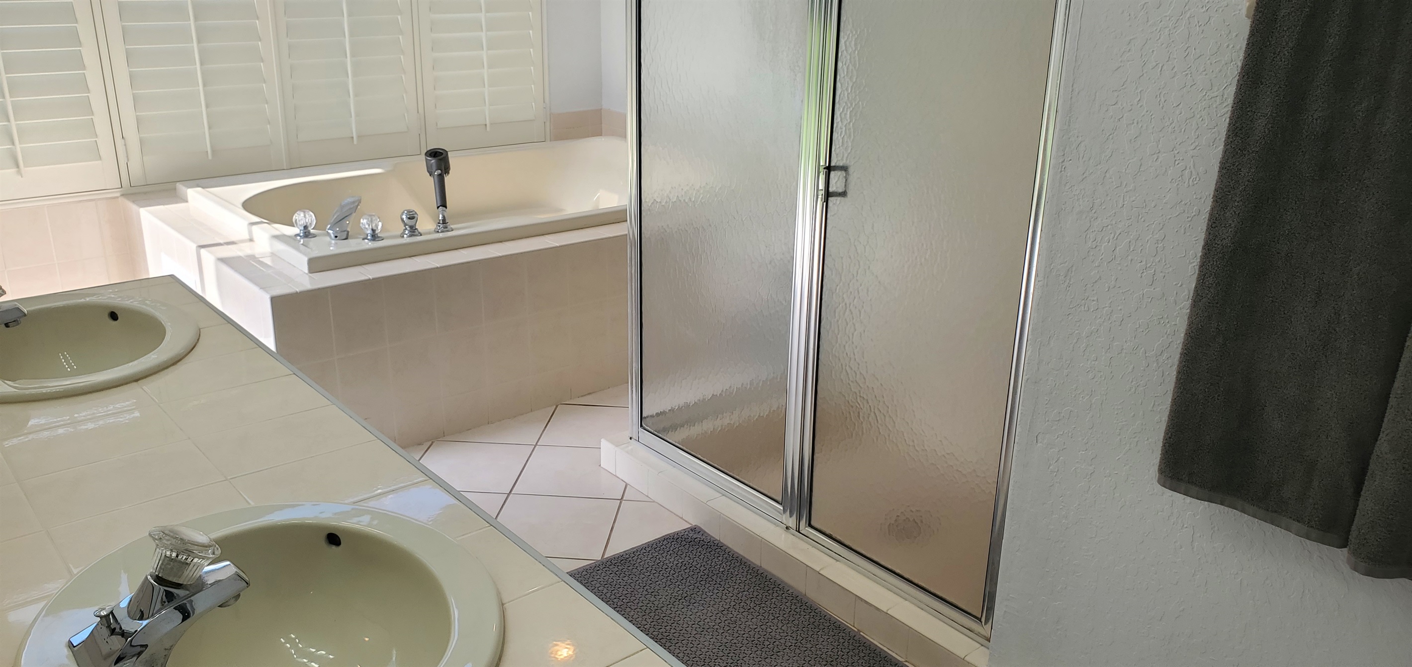 King private bathroom with jet tub and walk in shower, double sinks