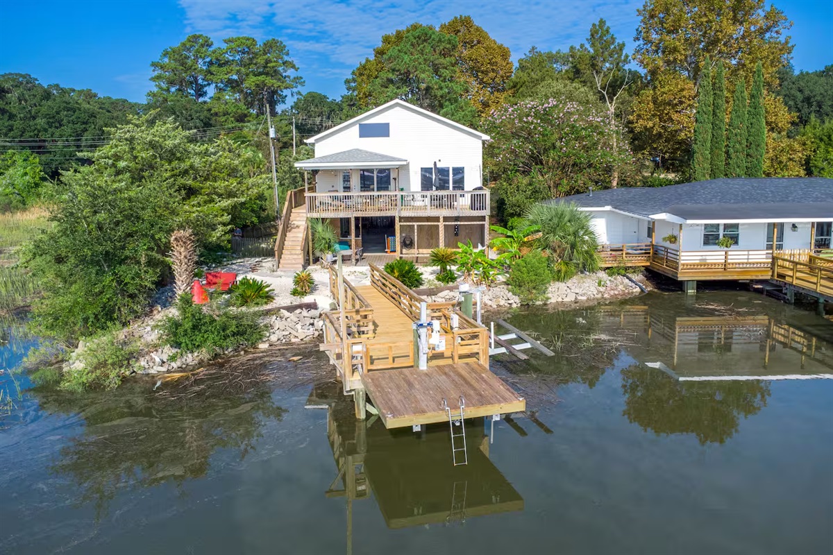 This waterfront retreat welcomes you with tropical landscaping, a spacious upper deck, and direct access to the private dock—your serene escape starts here!