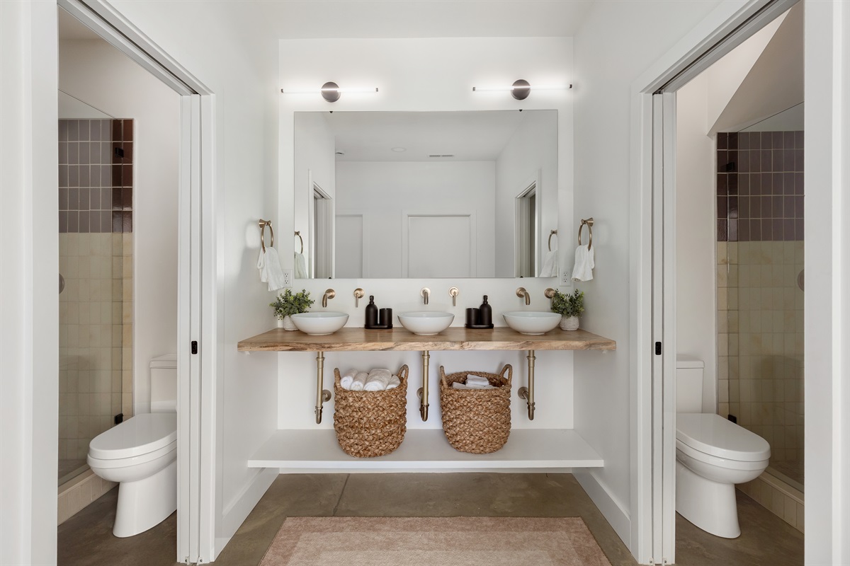{Shared Bath - Gallery House} The ultimate getting-ready space with dual showers, dual water closets,  and a wide triple vanity—perfect for groups.