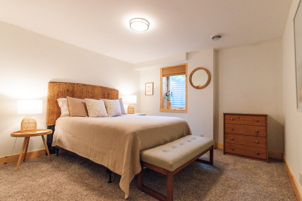 Comfortable queen bedroom with night stands and reading lamps. 