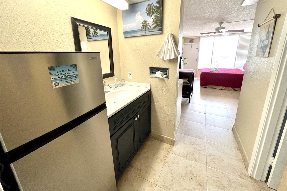 Big fridge with separate freezer, bring your ice cream! And vanity is still accessible if someone's in the bathroom.