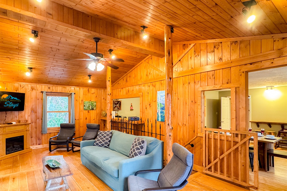 our cozy living room complete with a 55" Smart TV, seating, games, and wonderful views!