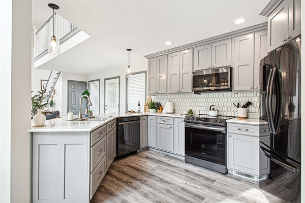 Modern elegance in the kitchen: new black stainless steel appliances, and the ease of soft-close cupboards and drawers in our fully equipped space.