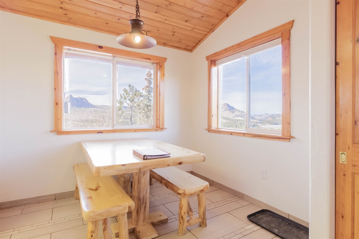 Bright dining area with large windows and peaceful outdoor views