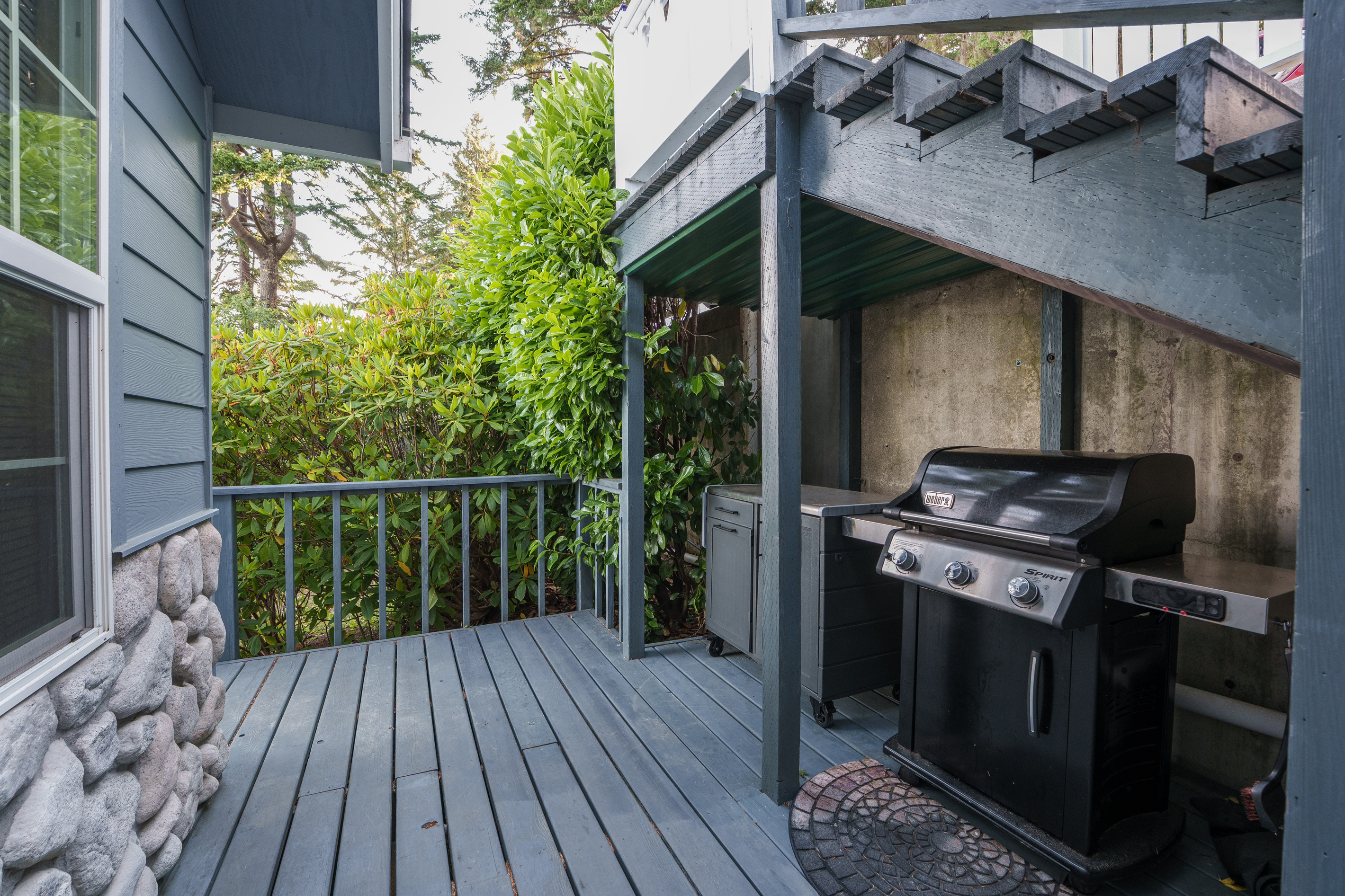Fire up the Weber grill in its convenient covered nook beneath the entry stairs—perfect for preparing an easy lakeside meal in any weather.