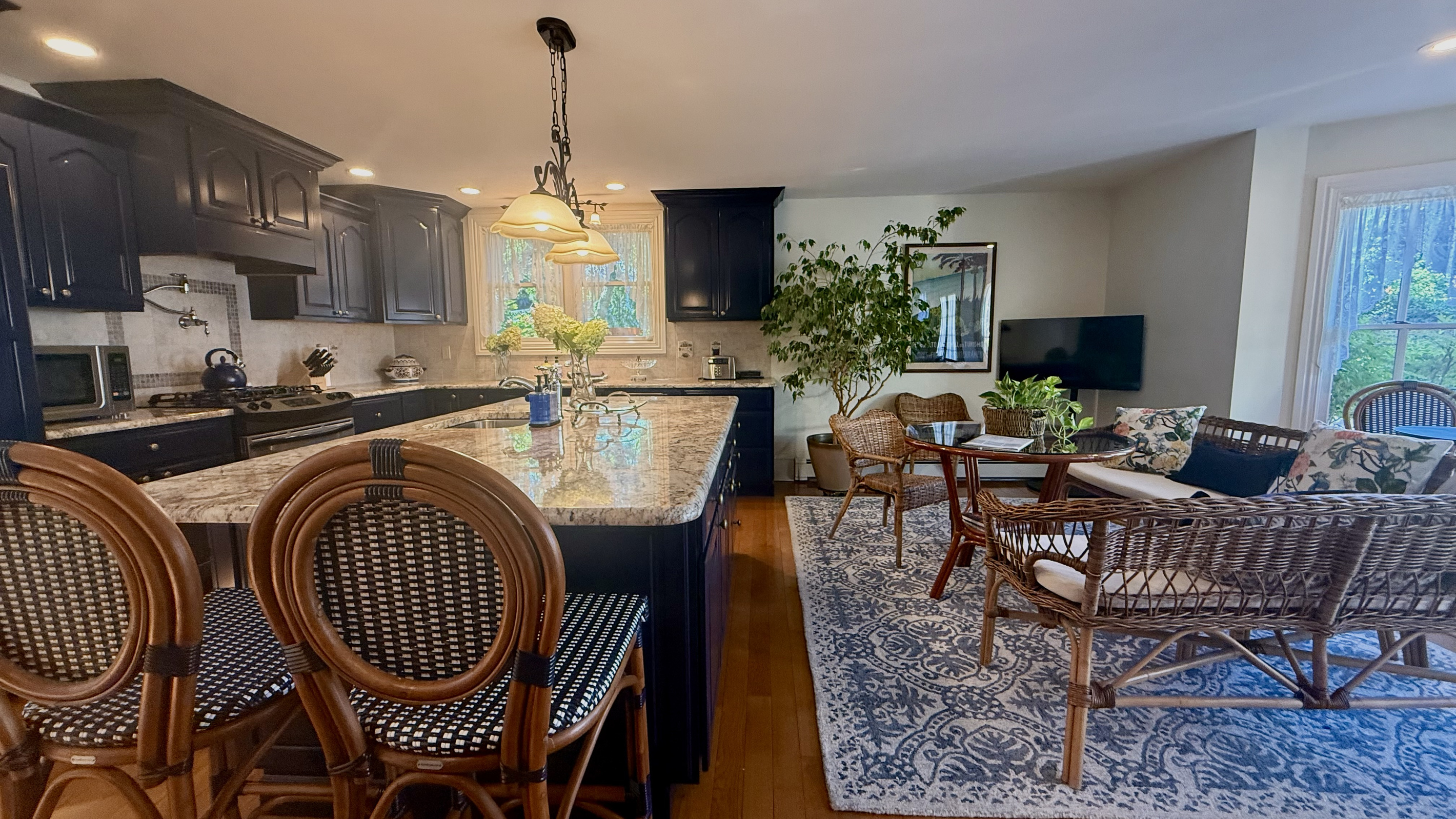 The open-concept kitchen flows into a cozy breakfast and sitting area—perfect for morning coffee, casual meals, or keeping the cook company.