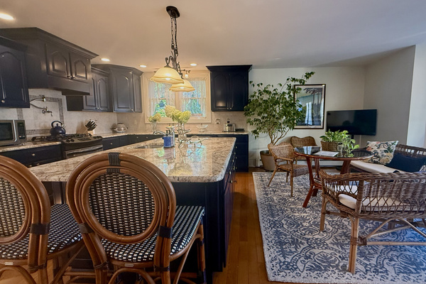 The open-concept kitchen flows into a cozy breakfast and sitting area—perfect for morning coffee, casual meals, or keeping the cook company.