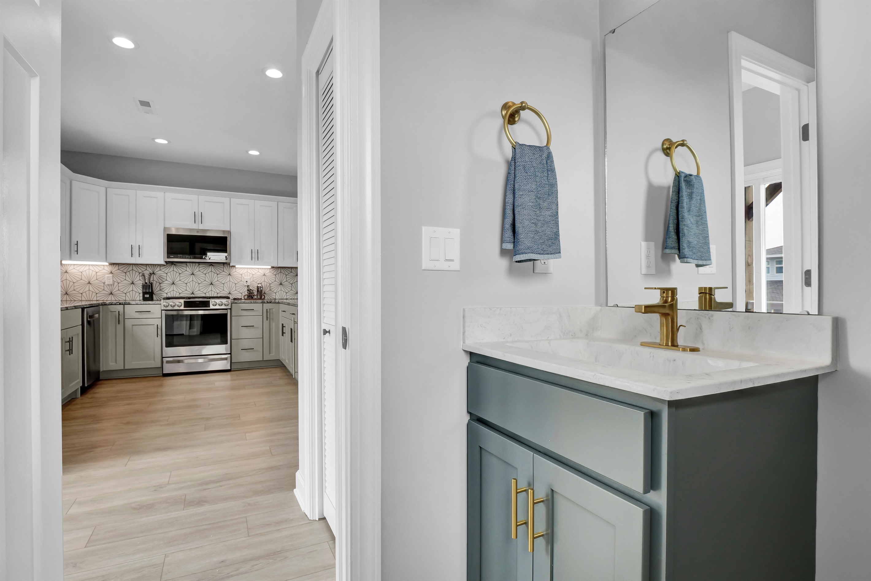 Stylish & guest-friendly half bath located off of the kitchen for quick and easy access.