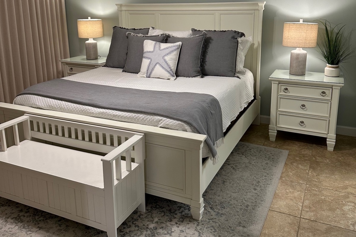 Master bedroom with king bed, ceiling fan, smart TV, clothing storage and ensuite bathroom